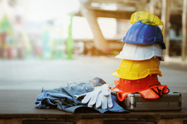 helmets stacked next to gloves and a uniform and equipment