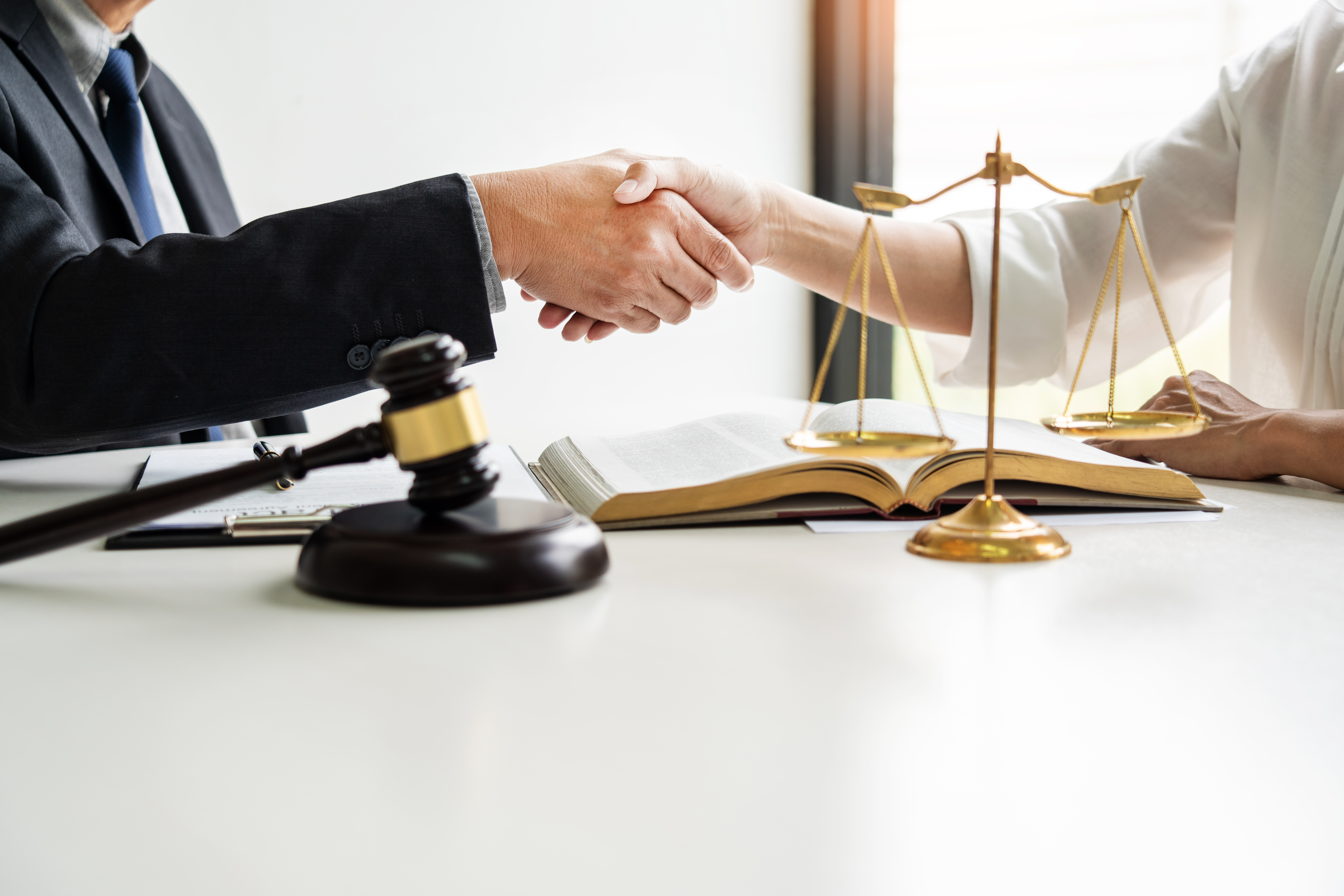 Handshake after cooperation between attorneys lawyer and clients discussing a contract agreement hope of victory over legal fighters, Concepts of law, advice.