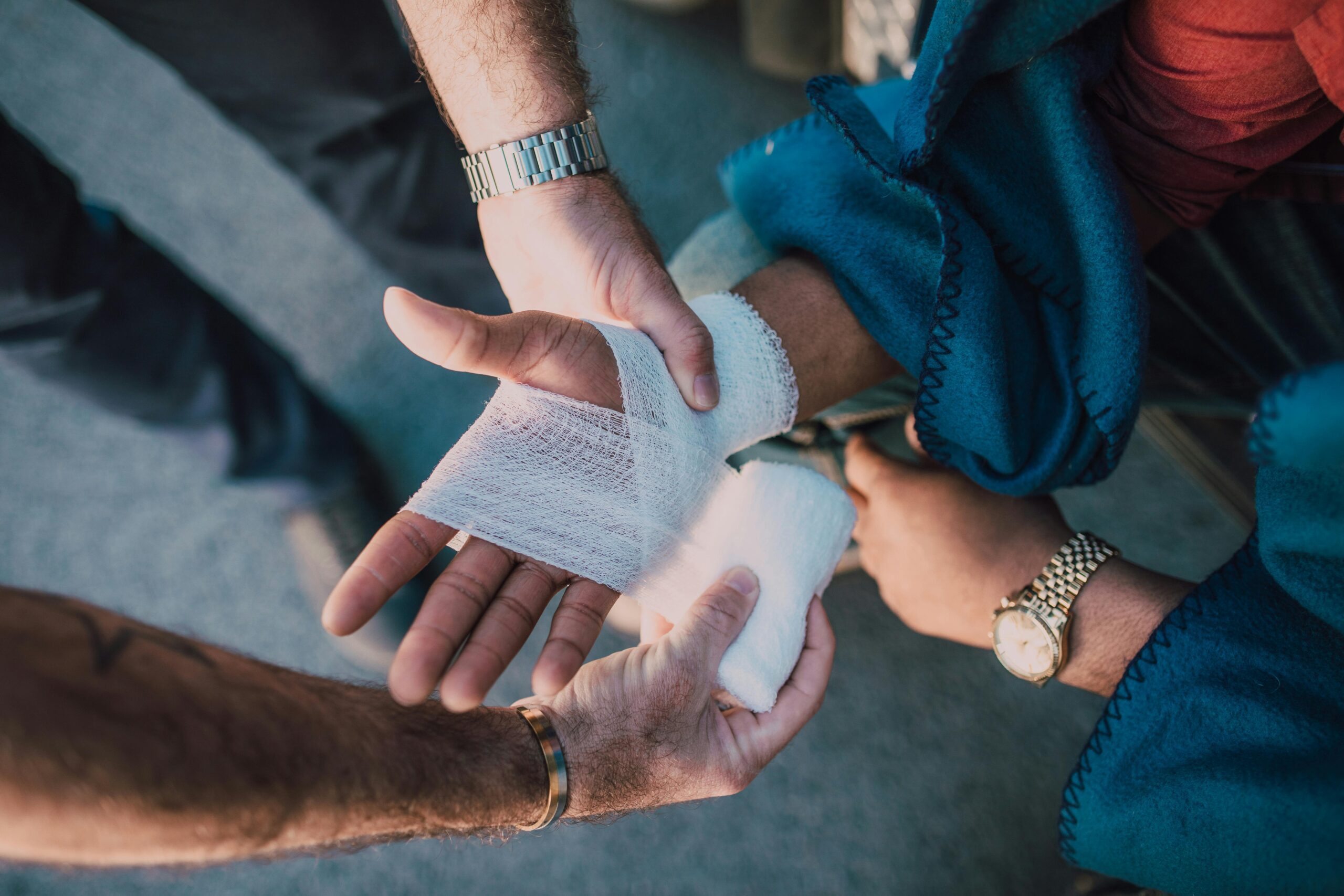 A woman's hand being wrapped in bandages by EMT close up image; DeSoto County Personal Injury Lawyers concept image
